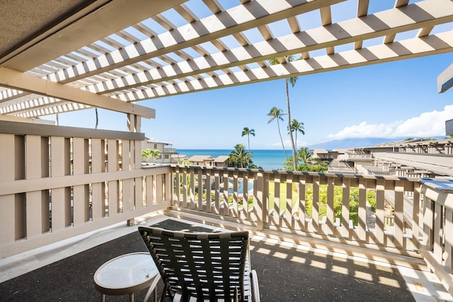 view of patio / terrace featuring a water view, a pergola, and a balcony