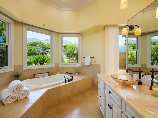 bathroom featuring tile patterned flooring, vanity, crown molding, and a healthy amount of sunlight