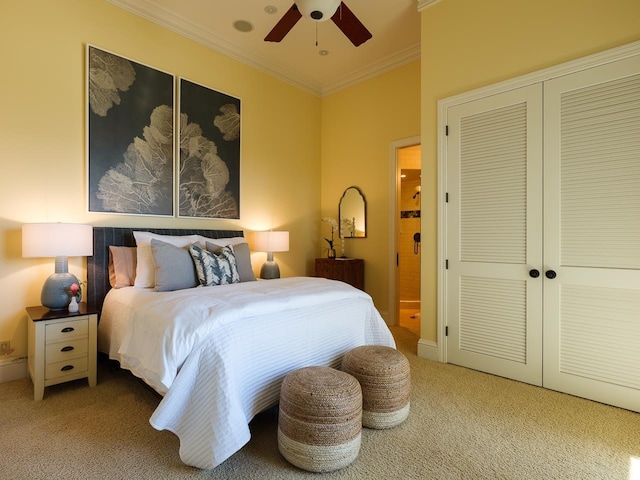 carpeted bedroom featuring a closet, ceiling fan, and ornamental molding