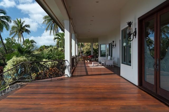 wooden deck with covered porch and french doors