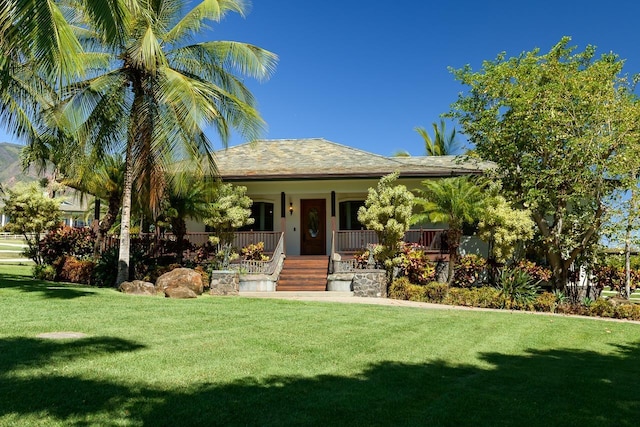 view of front of house featuring covered porch and a front yard