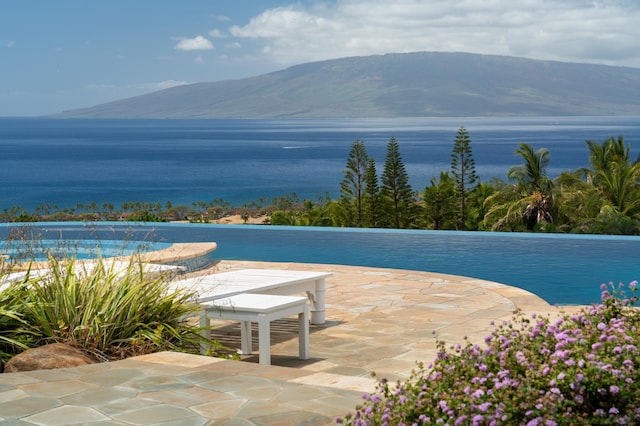 view of pool featuring a water and mountain view