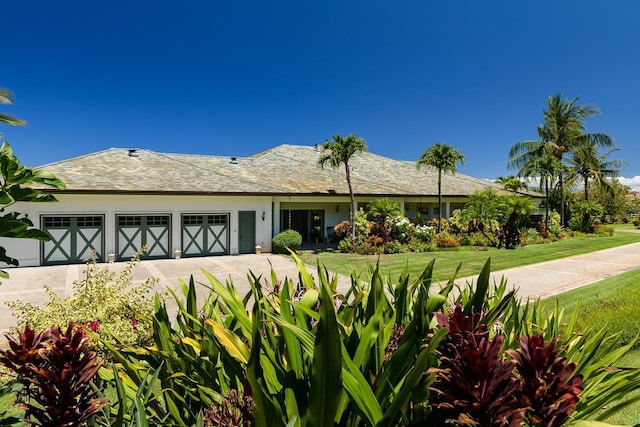 view of front of home with a front yard and a garage