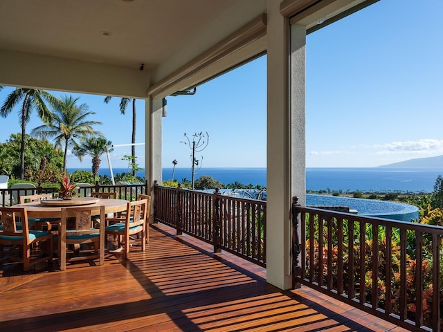 wooden terrace featuring a water view