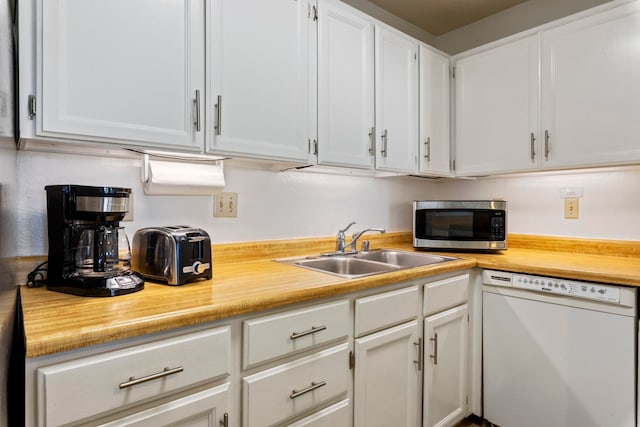 kitchen with dishwasher, sink, and white cabinetry