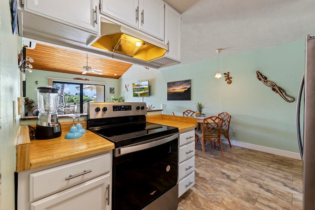 kitchen featuring white cabinets, lofted ceiling, hanging light fixtures, appliances with stainless steel finishes, and ceiling fan