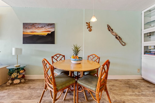 dining space featuring a textured ceiling