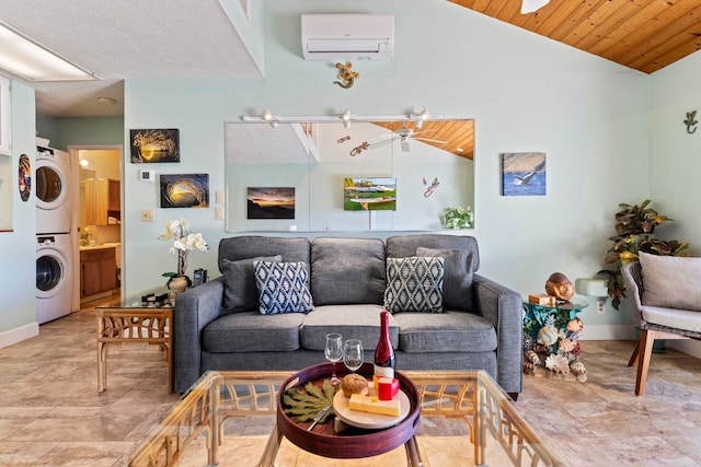 living room with an AC wall unit, vaulted ceiling, stacked washing maching and dryer, ceiling fan, and wooden ceiling