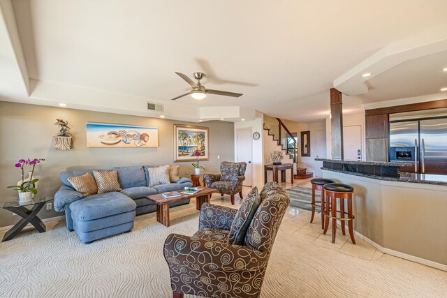 carpeted living room with ceiling fan