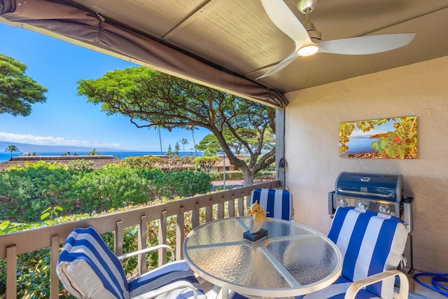 balcony featuring ceiling fan, a water view, and grilling area