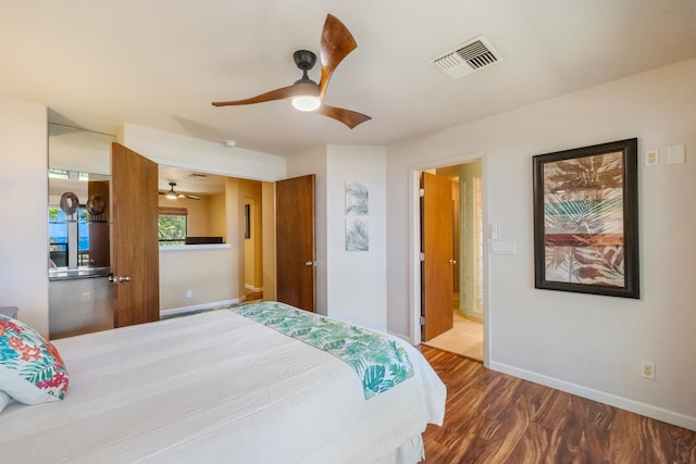 bedroom featuring connected bathroom, hardwood / wood-style flooring, and ceiling fan