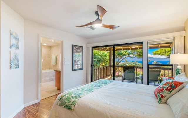 bedroom with connected bathroom, ceiling fan, access to outside, and multiple windows