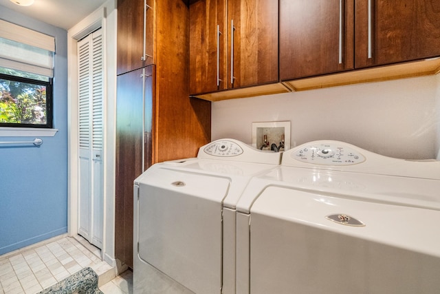 clothes washing area featuring cabinets, light tile patterned floors, and separate washer and dryer