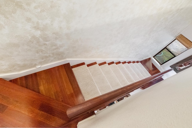 stairway with a textured ceiling