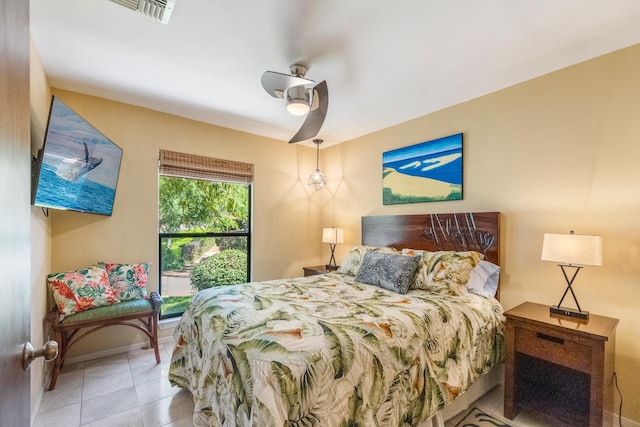 bedroom with ceiling fan and light tile patterned flooring