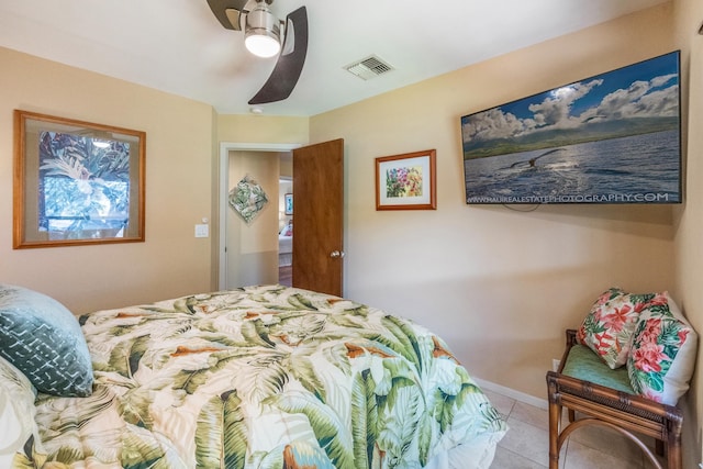 bedroom with ceiling fan and light tile patterned floors