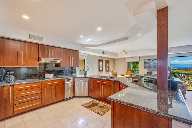 kitchen with kitchen peninsula, tasteful backsplash, sink, dark stone countertops, and light tile patterned flooring