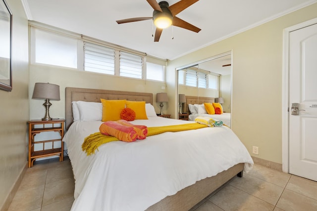 tiled bedroom with baseboards, a closet, crown molding, and a ceiling fan