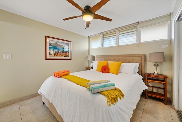 tiled bedroom with a ceiling fan and baseboards