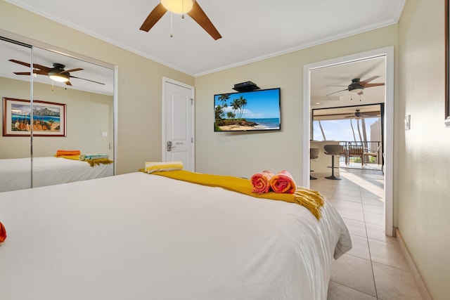 bedroom featuring light tile patterned flooring, ornamental molding, baseboards, and a ceiling fan