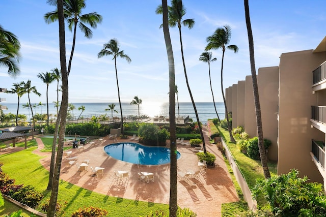 pool with a water view and a patio area