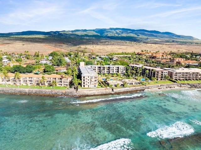 birds eye view of property with a water and mountain view