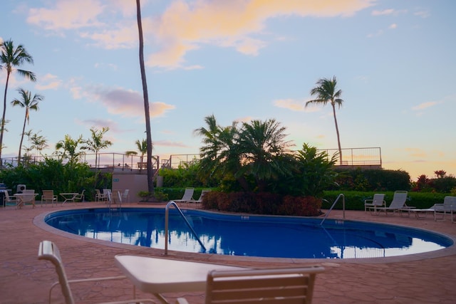 pool with fence and a patio