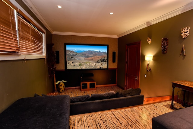 home theater room featuring ornamental molding and wood-type flooring