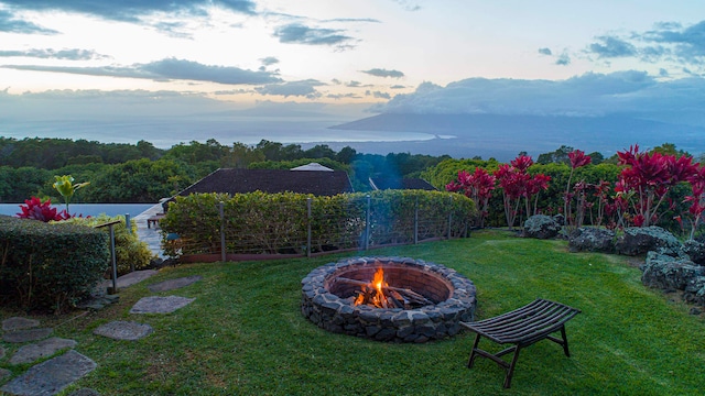 yard at dusk featuring a fire pit