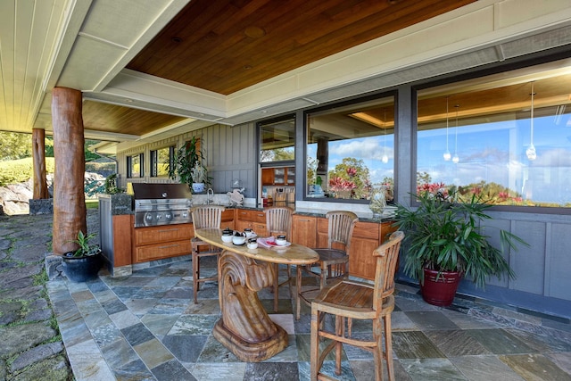 view of terrace featuring an outdoor kitchen and grilling area