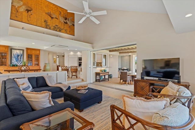 living room with ceiling fan and a high ceiling