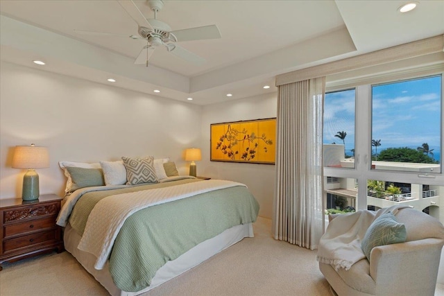 bedroom featuring light colored carpet, multiple windows, and ceiling fan