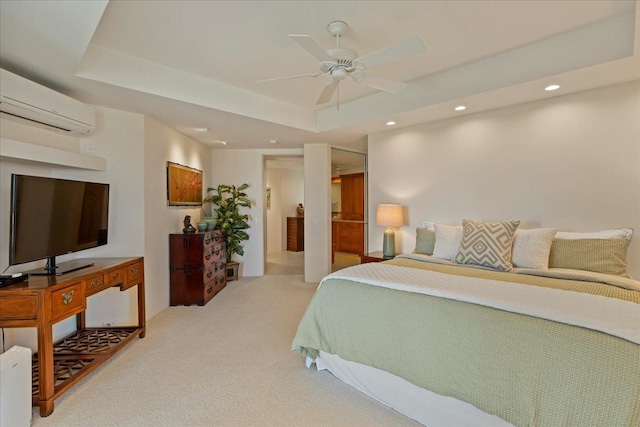 carpeted bedroom with a raised ceiling, an AC wall unit, and ceiling fan