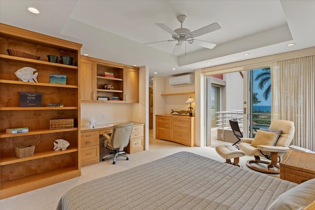 carpeted bedroom featuring a tray ceiling, access to outside, a wall mounted air conditioner, and ceiling fan