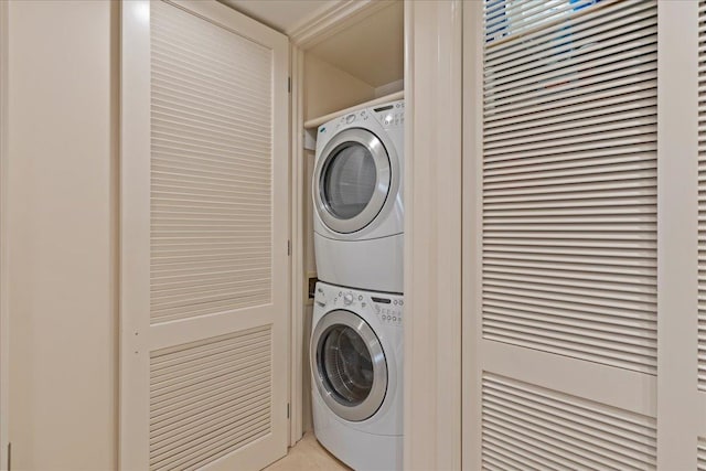 laundry area with stacked washer / dryer