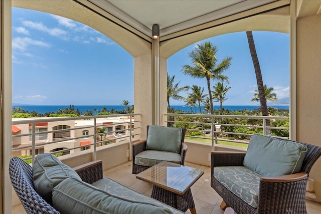 view of patio featuring a water view and a balcony