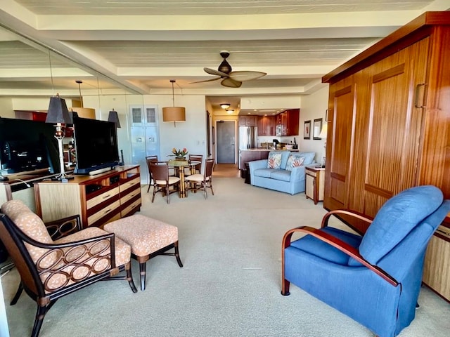 living room with ceiling fan and beamed ceiling