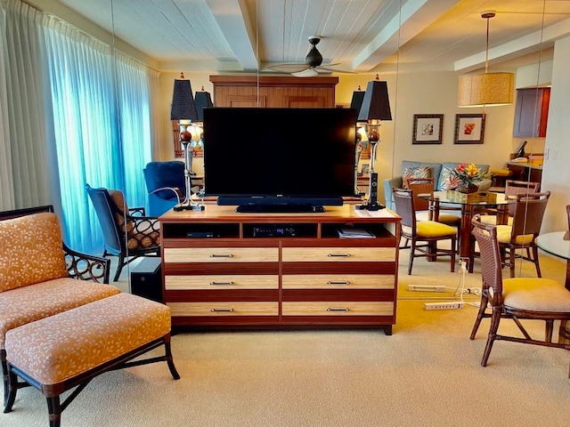 interior space with ceiling fan and beamed ceiling