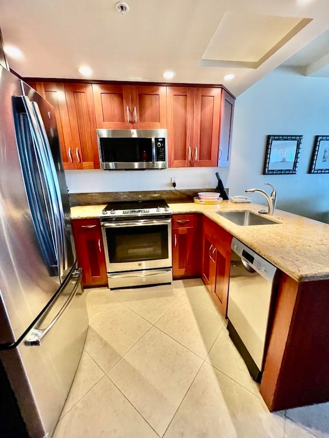 kitchen with kitchen peninsula, sink, light tile patterned floors, and stainless steel appliances