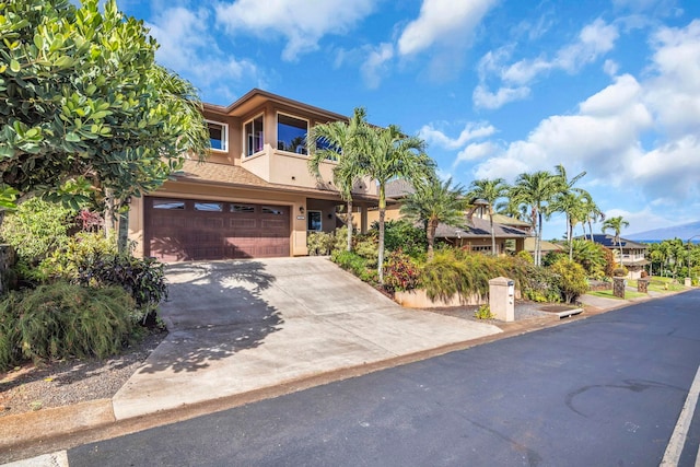 207 Kahana Ridge Dr Unit 132, Lahaina, HI 96761 - view of front of home with stucco siding, a garage, concrete driveway, and a balcony