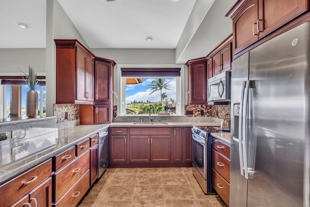 207 Kahana Ridge Dr Unit 132, Lahaina, HI 96761 - kitchen featuring appliances with stainless steel finishes, a sink, light stone counters, and decorative backsplash