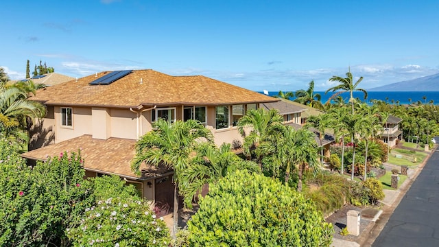 207 Kahana Ridge Dr Unit 132, Lahaina, HI 96761 - view of front facade with solar panels, stucco siding, and a shingled roof