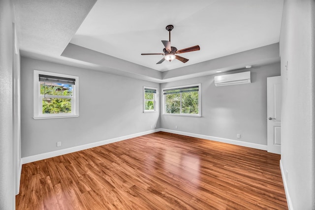 207 Kahana Ridge Dr Unit 132, Lahaina, HI 96761 - spare room with a wall unit AC, wood finished floors, baseboards, and a raised ceiling