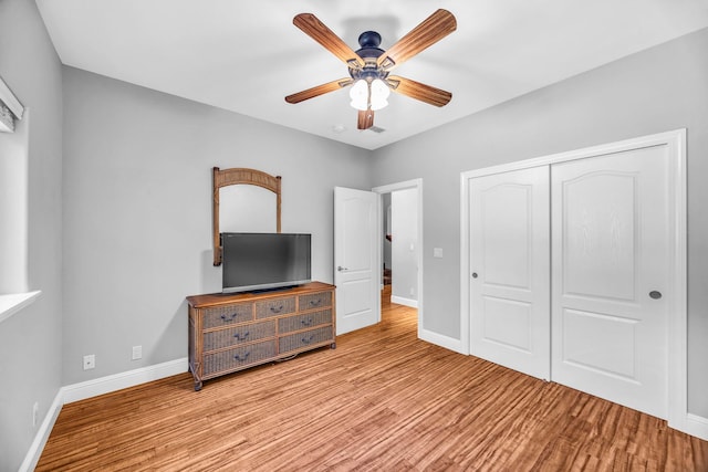 207 Kahana Ridge Dr Unit 132, Lahaina, HI 96761 - unfurnished bedroom with wood finished floors, a closet, baseboards, and a ceiling fan