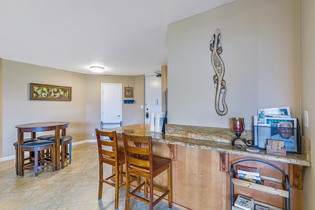 kitchen featuring light stone countertops and light tile patterned floors