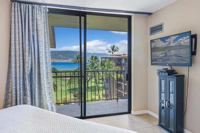 tiled bedroom featuring access to exterior and multiple windows