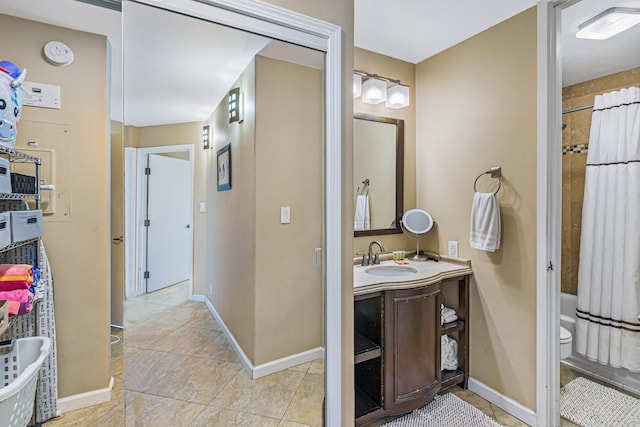 bathroom with tile patterned flooring, shower / bath combo, and vanity