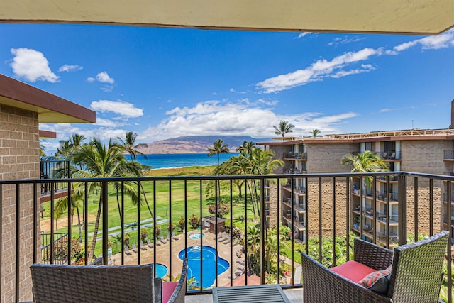 balcony featuring a water view