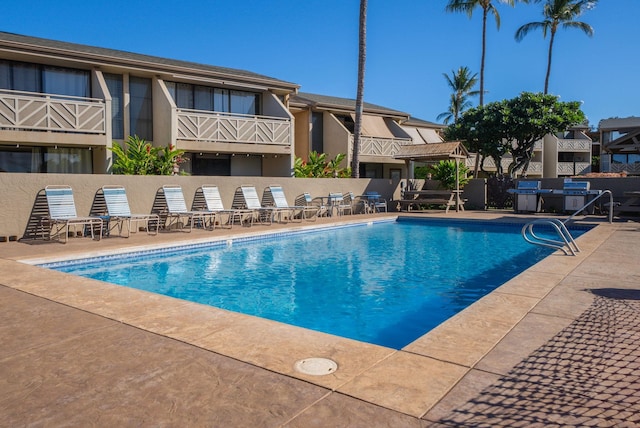 view of swimming pool with a patio