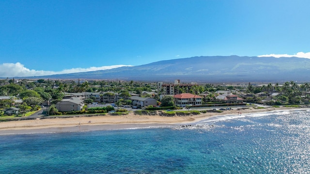 birds eye view of property with a view of the beach and a water and mountain view